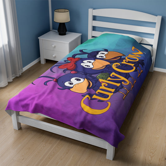 Soft kids’ blanket with a large Curly Crow logo in the center, perfect for snuggles and storytime.