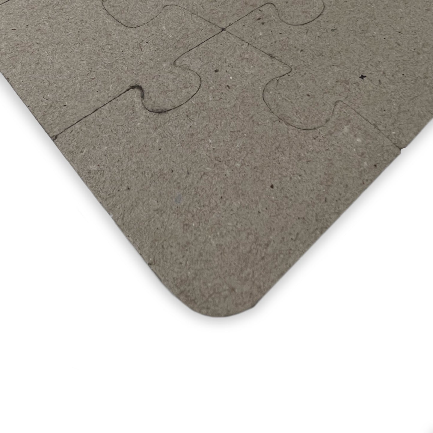Close-up of the puzzle's cardboard back, showcasing smooth, rounded corners for toddler safety and long-lasting durability.