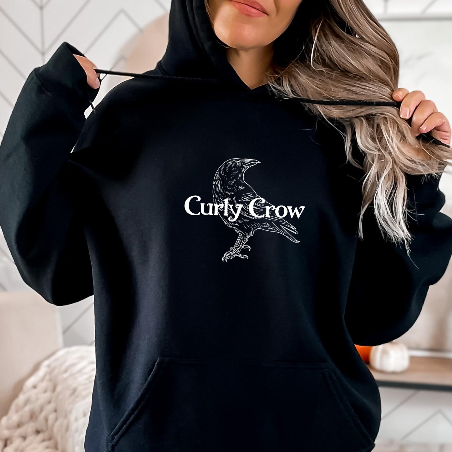 Female wearing a Curly Crow logo sweatshirt hoddie