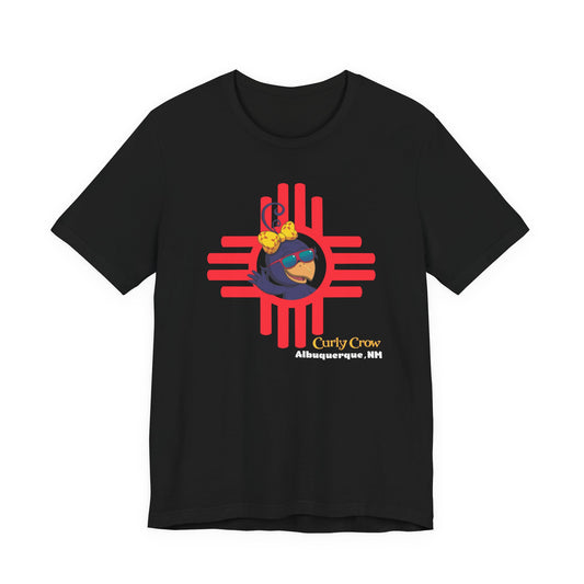 Black t-shirt with a colorful Curly Crow New Mexico Zia graphic design on a white background