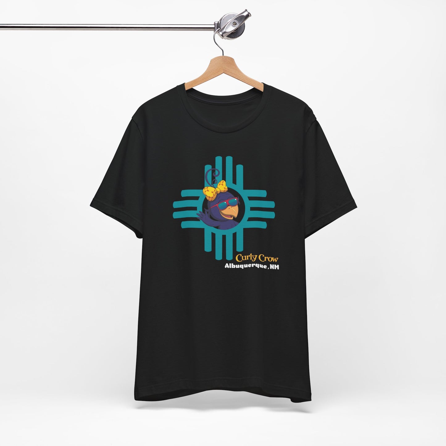 Black t-shirt with a colorful Curly Crow New Mexico Zia graphic design on a white background