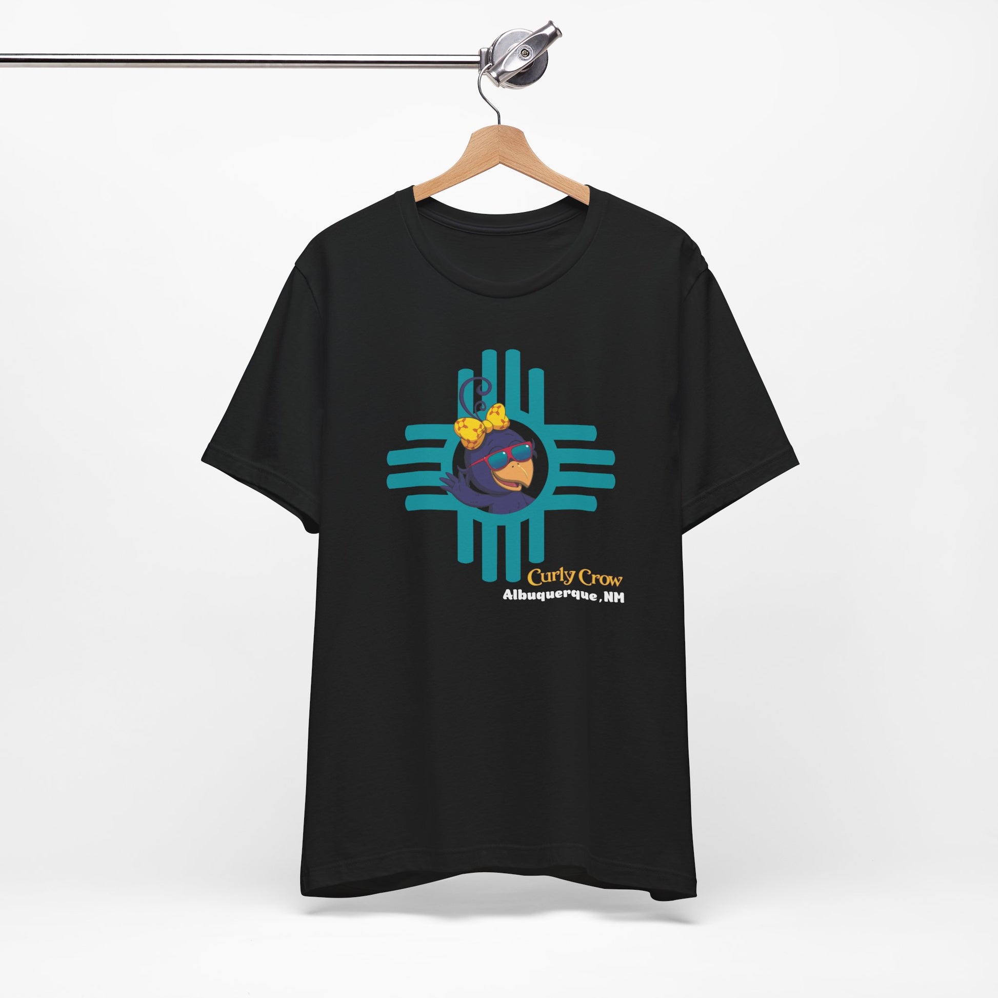 Black t-shirt with a colorful Curly Crow New Mexico Zia graphic design on a white background