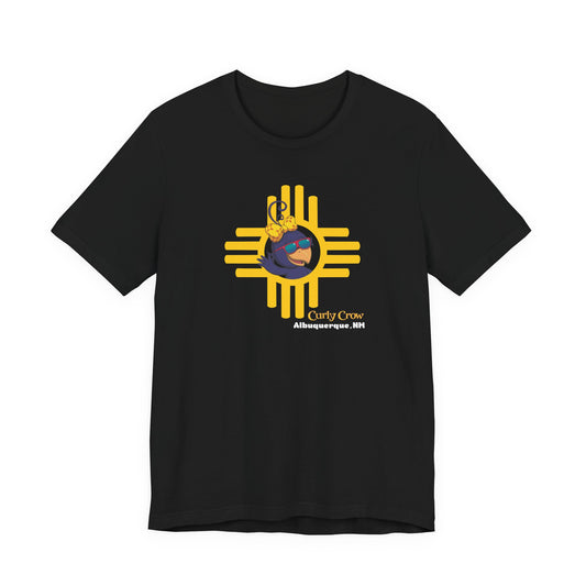 Black t-shirt with a colorful Curly Crow New Mexico Zia graphic design on a white background