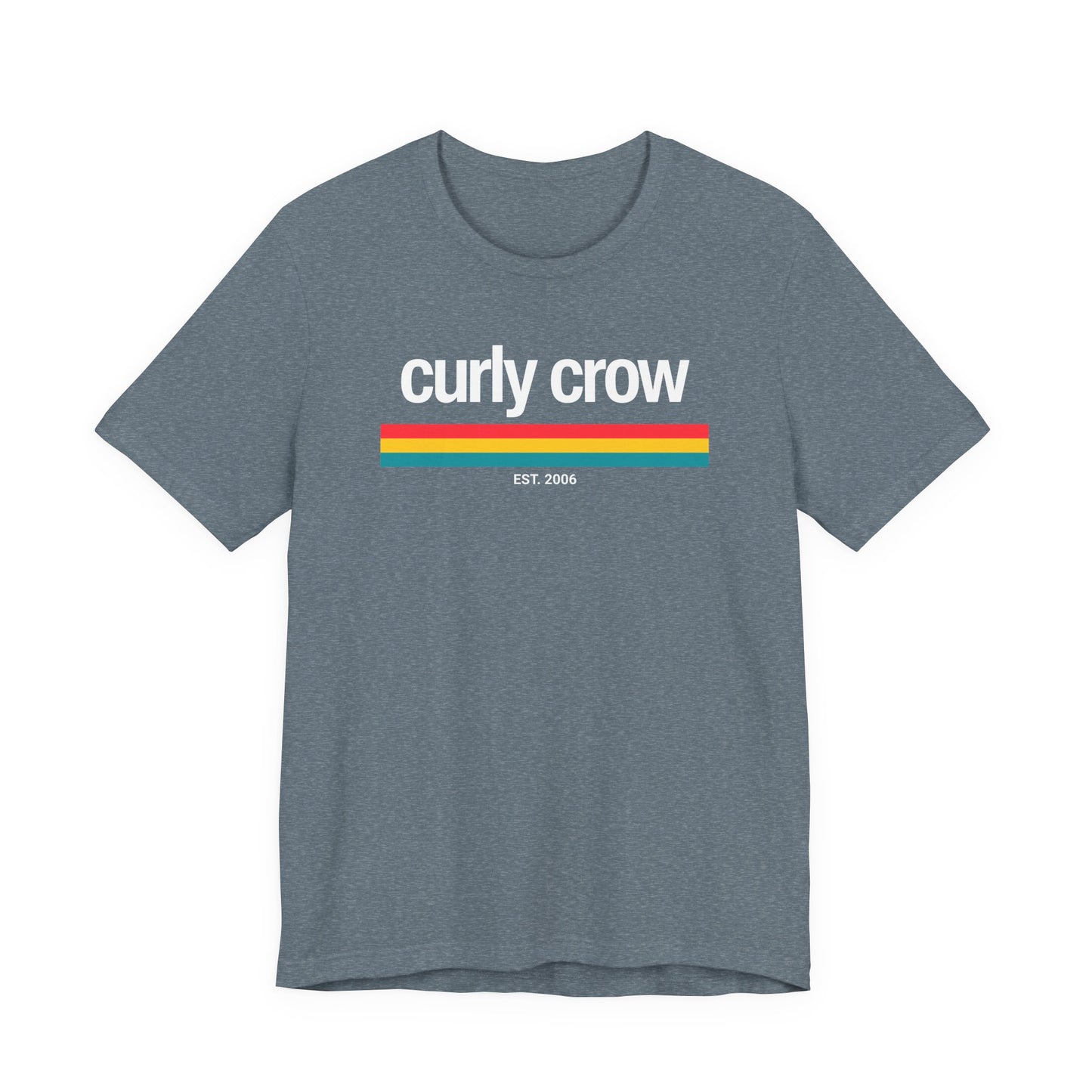 A heather gray short-sleeve t-shirt with a retro-style graphic on the chest featuring the text 'curly crow' in white, a horizontal stripe pattern in red, yellow, and teal, and 'EST. 2006' printed below.