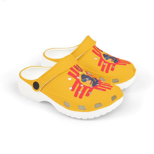 Yellow children's clogs with Curly Crow character and NM Zia design on a white background
