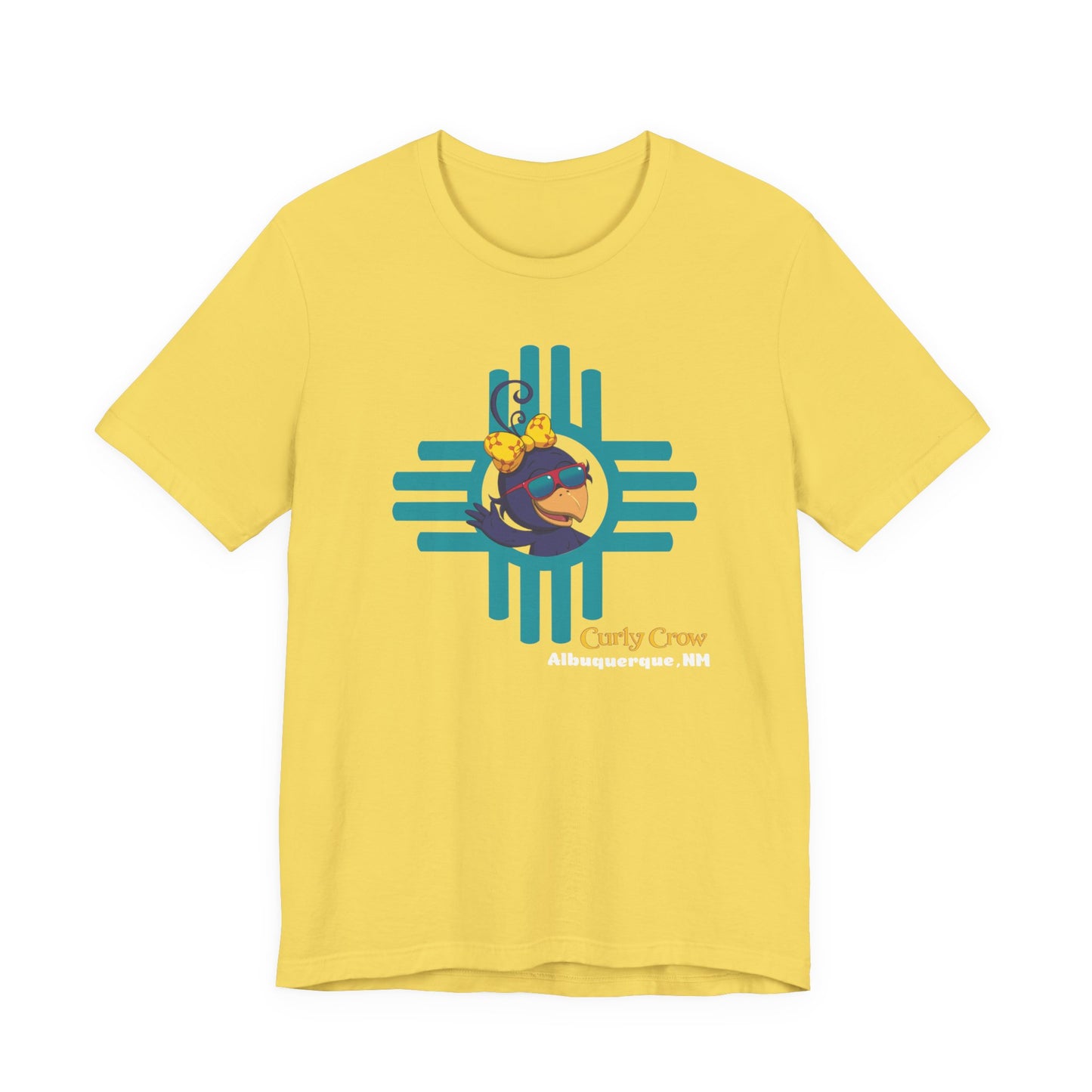 Yellow t-shirt with a colorful Curly Crow New Mexico Zia graphic design on a white background