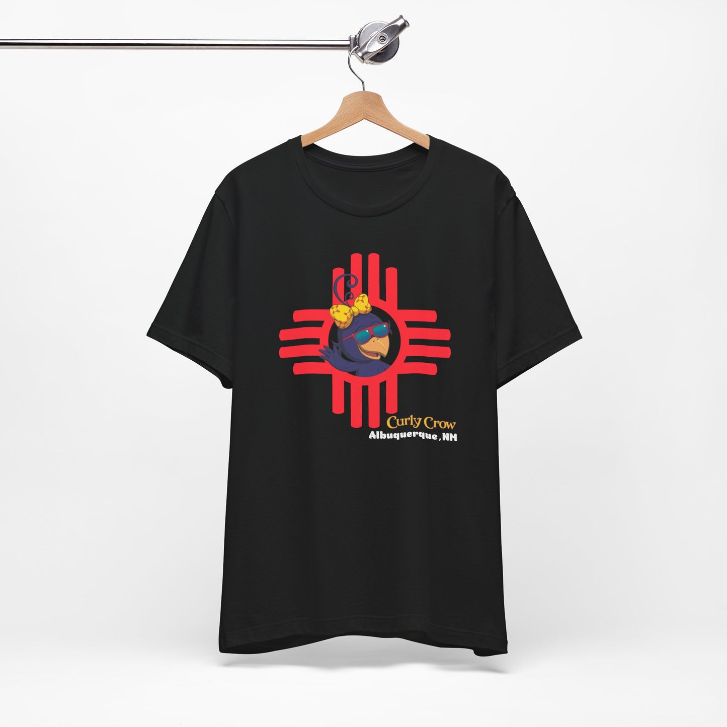 Black t-shirt with a colorful Curly Crow New Mexico Zia graphic design on a white background
