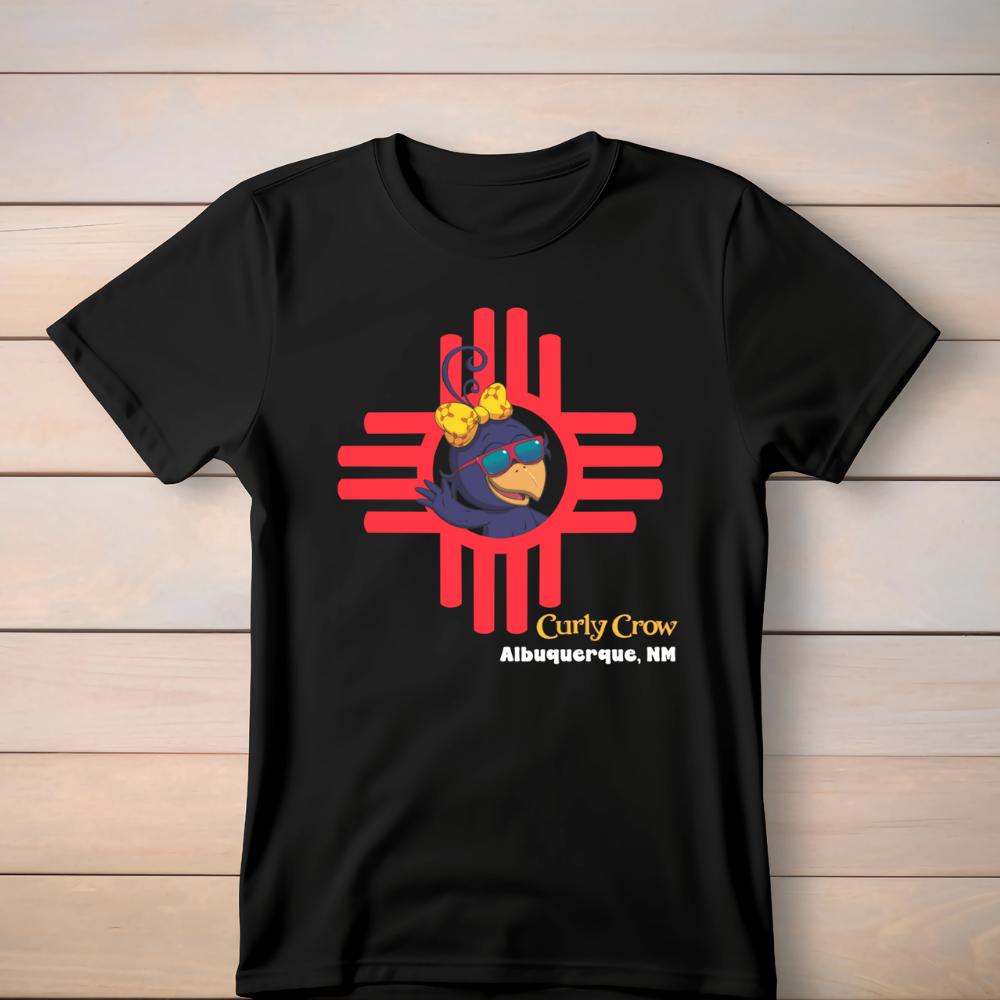 Black t-shirt with a graphic design on a wooden surface